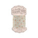 Spool of light beige with flowers and brown pin-dot bias tape isolated on a white background
