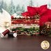 A stack of the fabrics included in the Holiday Feather & Flourish collection, with poinsettias and trees and a pinecone and thread.