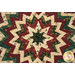 A super close up on the center of the table topper, demonstrating fabric colors and print details on the folded points.
