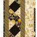 A super close up on the borders of the fabric, showing the various cream, black, and gold fabric prints.