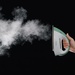 A model holds the iron and demonstrates the steam function on a black background.