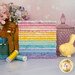 A stack of the fabrics included in the Tonga Blossom FQ Bundle, with flowers and jars and a bird and thread.