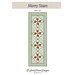 Front of the pattern featuring the Merry Stars table runner.