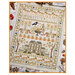 The finished cross-stitch sampler featuring a house, floral motifs, pumpkins, squirrels, and crows surrounded by coordinating autumn decor.  
