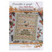 The front of the october sampler pattern featuring a house, floral motifs, pumpkins, squirrels, and crows surrounded by coordinating autumn decor.  