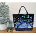 A Playing with Panels Market Tote colored in blue and cyan florals and butterfly-themed fabric, staged with coordinating decor.