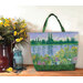 A Playing with Panels Market Tote colored in green, blue, and floral impressionist-themed fabric, staged with coordinating decor.