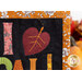 A super close up on the appliqué leaf in place of the heart, showcasing the hand-embroidered details.