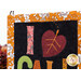 A closer look at the wall hanging, demonstrating fabric colors and details on the project as well as the binding.