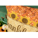 A close-up on the pillow showing color and pattern details on the fabrics and scalloped border.