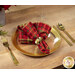 A different angle of a place setting with the reversible red and green plaid fabric of the napkin faced out.