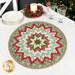 The completed Folded Star Table Topper colored in cream, teal, green, and red fabrics from the Sugarberry collection by Andover Fabrics, staged on a wood table with festive coordinating kitchen decor.