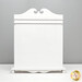 The large sized Quiltkeeper, a white decorative board with a scalloped top and a curved base, set against a gray background.