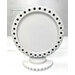 The fully assembled and painted Round Wood Décor Frame - Dots, staged on a white tabletop.