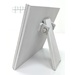 The fully assembled and painted Spring Comes Again Shiplap Frame Cross Stitch Display, staged on a white tabletop and rotated to show the back frame leg.