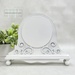 The fully assembled and painted Fleur Round Cross Stitch Framer, staged on a white tabletop.