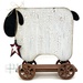 The fully assembled and painted Primitive Sheep Cross Stitch Display, staged on a white tabletop.