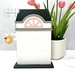 The fully assembled and painted City Flower Shop Cross Stitch Display Backer, staged on a white tabletop.