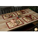 A shot of a table with four table settings using the placemats and coordinating cutlery, napkins and decor.