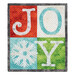 Christmas themed table top banner featuring a grid of four squares with an appliqué snowflake and letters to spell "Joy" in festive colors, isolated on a white background.