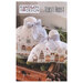 Front of pattern showing the completed cross stitch designs displayed in a wooden basket with pine branches. .