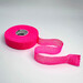 A roll of Bright Pink Thimtech Thimble Tape on its side and unraveled to show the weave, staged on a white background.