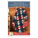 Front cover of the pattern featuring the finished rag quilt, colored in red, white, and blue flannels from the Primo Plaids - Americana collection, hung on a white quilt ladder and staged in a warmly lit cabin.