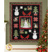 The completed Winter Nights in the Forest quilt, colored in black, red, green, and white fabrics from the Winter Friends collection from Moda Fabrics, hung on a sage green shiplap wall and staged with coordinating Christmas decor.