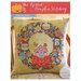 The front of the Christmas Wreath pillow cross stitch pattern from The Frosted Pumpkin Stitchery showing the finished product.