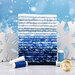 A stack of the fabrics included in the Frosted Wishes collection, with snowflakes and thread.