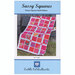 The front of the Sassy Squares quilt pattern displaying the finished product against a wood fence.