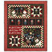 The completed Let it Snow quilt, colored in red, black, cream, and green flannels from the Holly Jolly fabric collection, isolated on a white background.