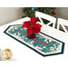 A shot of the runner staged on a bright white table with a red basket of red and gold poinsettias in the center.