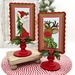 The fully assembled and painted Simply Scallop Rectangle Pedestal Frame, staged on a tabletop with coordinating winter decor, displaying a Santa and Rudolph-themed project.