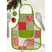 A completed Apron Casserole Hot Pad in Christmas themed fabrics beside a spatula and whisk.