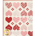 A close up on the upper left corner of the quilt, showing details on the patchwork hearts and nine-patches.