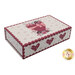 The decorative keepsake box for the quilt, featuring a heart design and floral patterns in shades of pink and red.