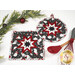 The completed Folded Star Hot Pad(s), shown in round and square options, colored in black, red, and white fabrics from the Blizzard Fun collection by Henry Glass Fabrics, staged with coordinating winter and kitchen décor.