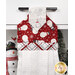 A head-on close up at the top of the hanging towel, showing details on the red fabric with snowmen and white fabric tab.