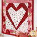 A stylized close up on one of the heart blocks, showing details on the fabric colors and prints as coordinating décor peeks into frame from the right side.