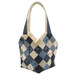 A blue and white patchwork tote bag with floral designs from the Bluebird's Nest collection by Kansas Troubles Quilters, isolated on a white background. 