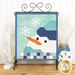 Winter themed table top banner featuring an appliqué snowman and snowflakes in cool blue and gray colors, hung on a display hanger and staged with coordinating decor.