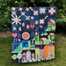 Colorful patchwork quilt featuring stars, hearts, musical notes, and abstract city scenes against a dark background.
