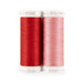 A pink and red spool of thread next to each other, isolated on a white background.