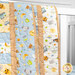 A close up shot of the Patchwork Baby Quilt kit draped over a crib. 