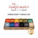 Colorful embroidery thread set displayed in a box, below a text graphic that reads, "The Samplemaker Block of the Month Embroidery Thread Set."