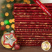 A stack of the eighteen fabrics included in the 18 HY Bundle Red/Gold by Stof Fabrics, staged with ornaments and thread.