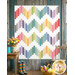 The completed Ridiculously Easy Jelly Roll Quilt in fabric from the Sweet Things collection, staged on a rustic paneled wall with wooden chair, cut flowers, and rainbow rubber boots. 