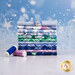A stack of the fabrics included in the Snowflake Wishes collection, with snow and snowflakes and thread.
