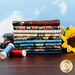 A stack of the fabrics included in the Historic Route 66 collection, with sunflowers and a vintage car toy and thread and a blue sky.